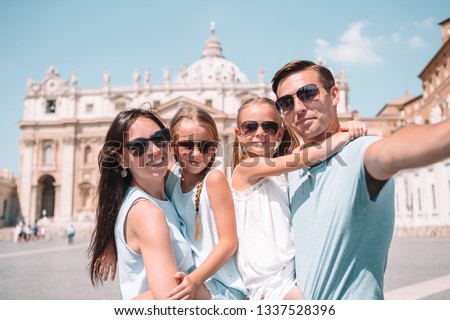 Happy young family taking selfie at St. Peter's Basilica church in Vatican city, Rome. Happy family on european vacation in Italy.