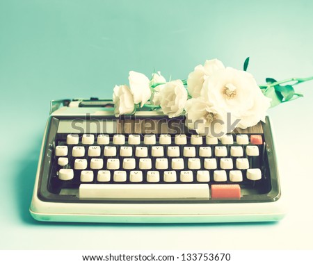 Vintage typewriter with white flowers