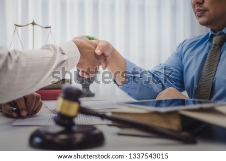 Businessman shaking hands with lawyers after discussing a contract agreement in office. justice and law ,attorney, court judge, concept.