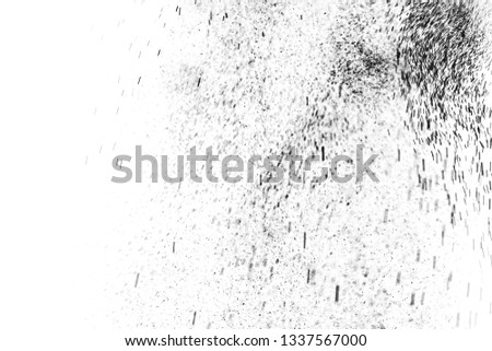 Black particles explosion isolated on white background. Abstract dust overlay texture.
