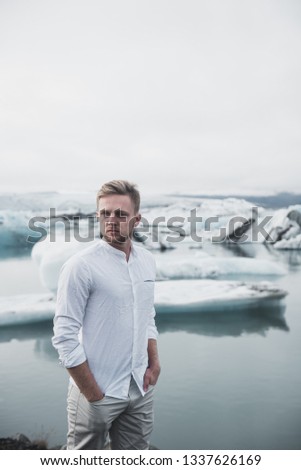 Young attractive man in Iceland , ice background