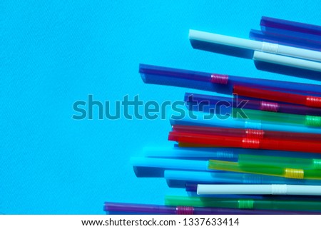 Colorful Plastic Cocktail Tubes Over Blue Background. Abstract Colorful Diagonal Lines. Colorful Background Textures.