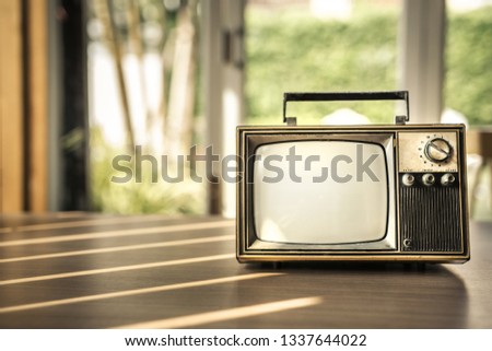 Antique, old television on wooden table decorated in coffee shop. Vintage TV with filter effect