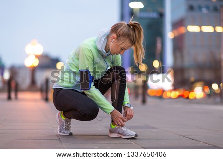 Female runner in city at night