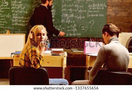 Group of attentive adult students with teacher in classroom at training. Concept education - back to school on green background. Teenage female student preparing for exams at college classroom.