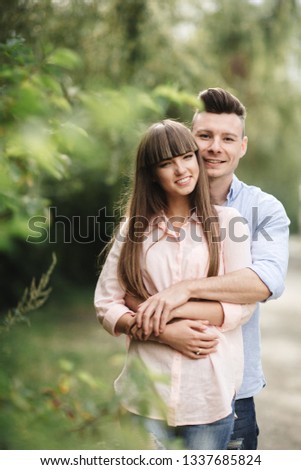 Loving young couple kissing and hugging in outdoors. Love and tenderness, dating, romance, family,