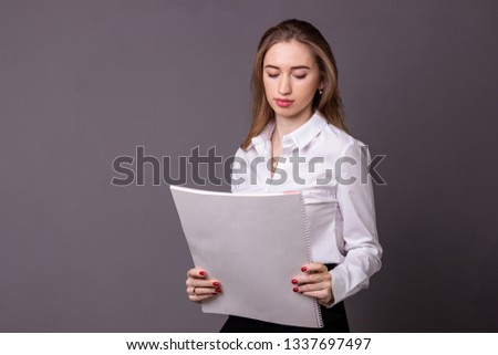 The girl in a white shirt and paper
