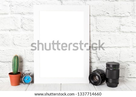 White empty photo frame against brick wall. Mockup with copy space.