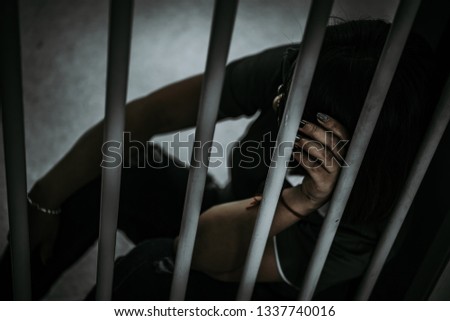 Portrait of woman desperate to catch the iron prison,prisoner concept,thailand people,Hope to be free.