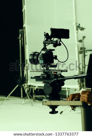 Video camera in film or movie production on tripod and professional gear which shooting in location or studio with crew team and beautiful prop or set and ready to online live broadcast or tv on air 
