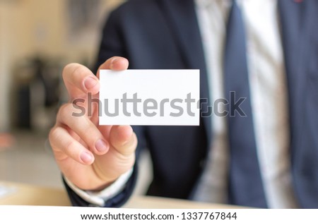 Business Card Mock-Up - Businessman Holding a Blank Card for Clients. Business Card Template.