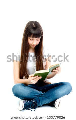 Small and beautiful girl reading a book