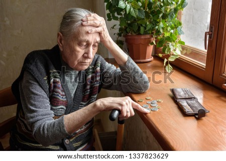 Portrait of an old woman counting money. The concept of old age, poverty, austerity. Royalty-Free Stock Photo #1337823629