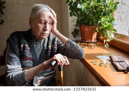 Portrait of an old woman counting money. The concept of old age, poverty, austerity. Royalty-Free Stock Photo #1337823635