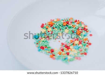 Selective focus Festive abstract multicolored candy sprinkles. Yellow red green orange blue circles, doodles, flowers, neon blurred. Easter, birthday greeting card or web banner concept
