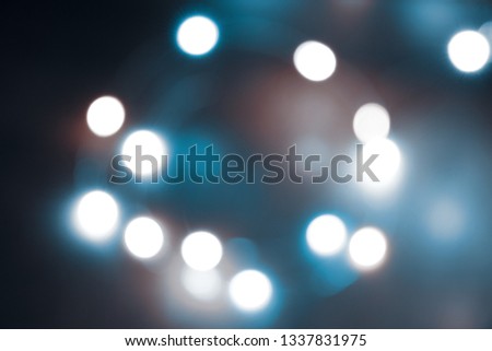 Abstract bokeh nigth background. Colorful magic lights background, decoration for the party. Neon light glowing effect. Blue glow