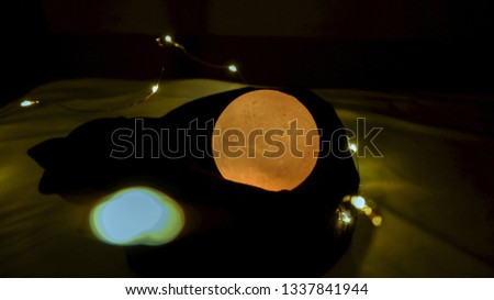 Yellow moon that shine or bright in the dark that has light around it with bleary background
