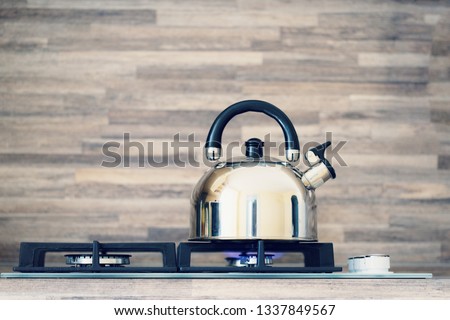 the kettle is heated on a gas stove
