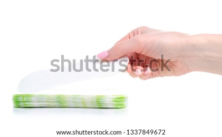 Sanitary pad daily panty liner in hand on white background isolation