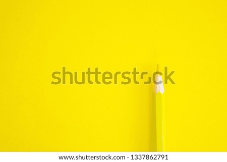 
yellow pencil on yellow background