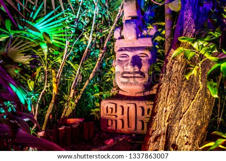 Tiki Statue glowing at night with different color