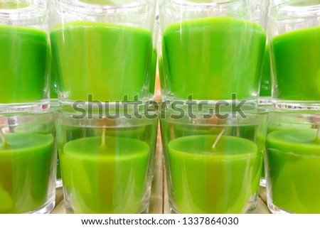 Group of green aroma candles in plastic pots close up. Relaxation, calm and aromatherapy symbol. Green spa candles.  Royalty-Free Stock Photo #1337864030