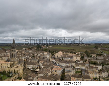 Aerial view of old town of Saint-Émilion, France on dramatic cloudy March afternoon