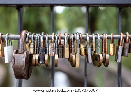 Metal padlocks hung on a bridge as a symbol of faithfullness in marriege