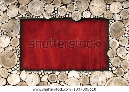 Wooden frame of sawn wood brown color on a red background.