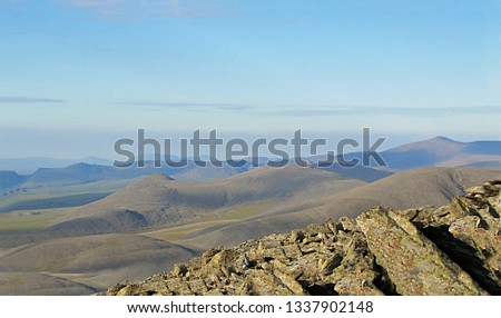 View from a high mountain in the tundra. Views of rivers, lakes, mountains and nearby mountains are photographed from the peaks of the Ural Mountains.