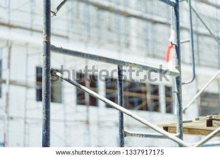Construction site background.Scaffolding or framework for buildings on Cement background.Industrial and under construction concept.