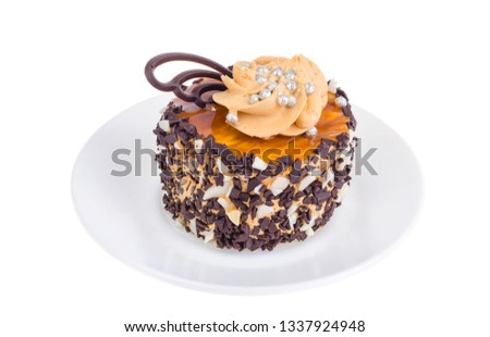 Caramel cake with butter cream and chocolate drops. Studio Photo