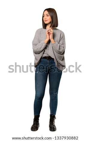 A full-length shot of a Young woman scheming something over isolated white background
