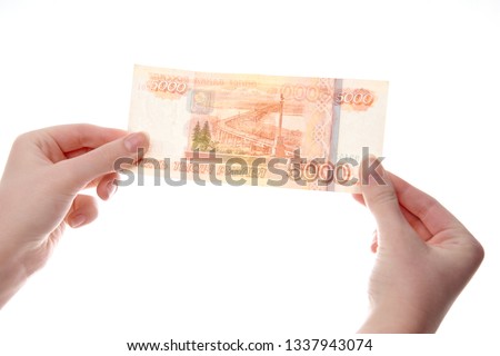 bill 5000 rubles in the hand of a girl on a white background