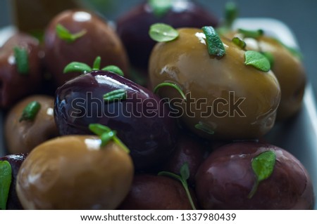 Greek olives with herbs in a serving dish