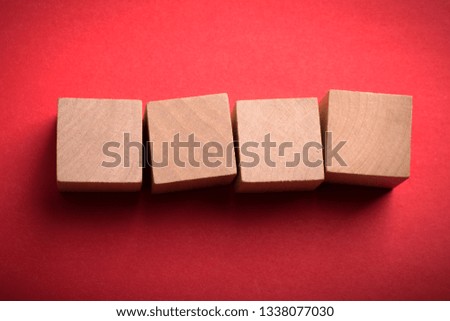 Four blank wooden blocks isolated on color background.