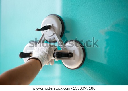 The glass technician is installing the glass with suction cups for installation. Royalty-Free Stock Photo #1338099188