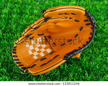 Baseball glove on grass background