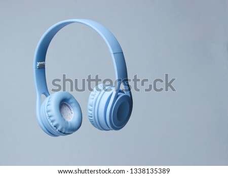 3D surround photo blue wireless headphones on gray background. Royalty-Free Stock Photo #1338135389