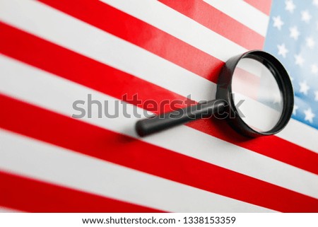 The American flag is viewed through a magnifying glass. Spies and surveillance USA concept. Control of the state of the United States. War Terrorism Theft Concept