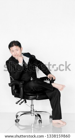 businessman in suit holding pen over white background 