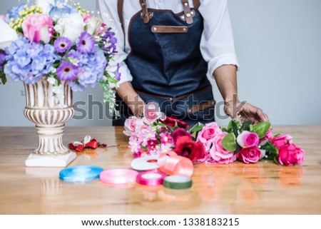 Arranging artificial flowers vest decoration at home, Young woman florist work making organizing diy artificial flower, craft and hand made concept.