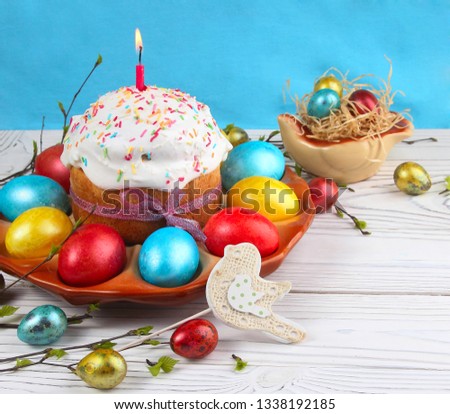 Easter bread and colorful eggs on a wooden, white background. Easter background. 