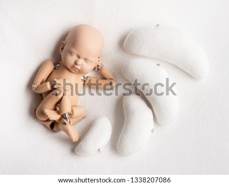 Movable action figure of a newborn kid with bean pillows