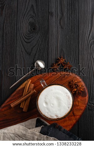 Coffee with milk on dark wooden background top view