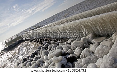 Frozen pier at Afsluitdijk - major causeway in Netherlands