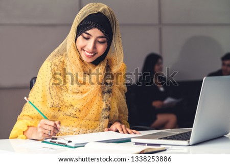 Successful Middle Eastern Muslim businesswoman working in office. International business success concept.