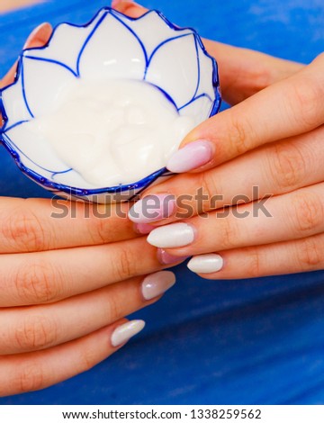 Woman holding bowl with cream moisturizer. Girl ready to applying cosmetic mask moisturizing to her face. Beauty treatment. Skincare.