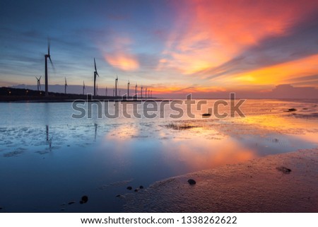 Asia culture - Beautiful landscape of sea level reflect fantasy dramatic sunset sky  in Gaomei wetlands , the famous travel attractions in Taichung, Taiwan.