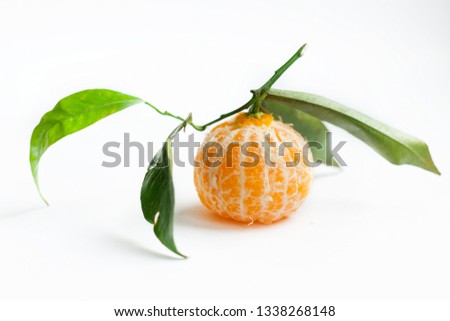 The mandarin without peel with green leafs on white background free space for text isolate